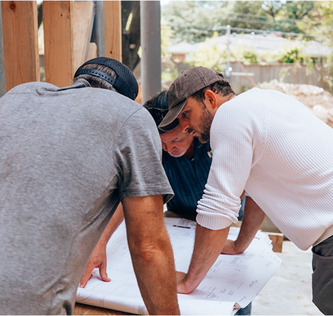 Workmen collaborating on a building site